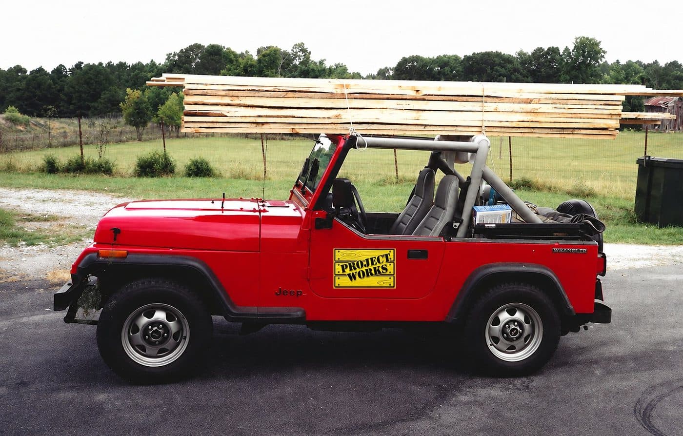Early Project Works Jeep loaded with lumber